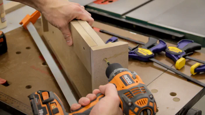 A screw is used to attach the MDF back piece to the sides and bottom.