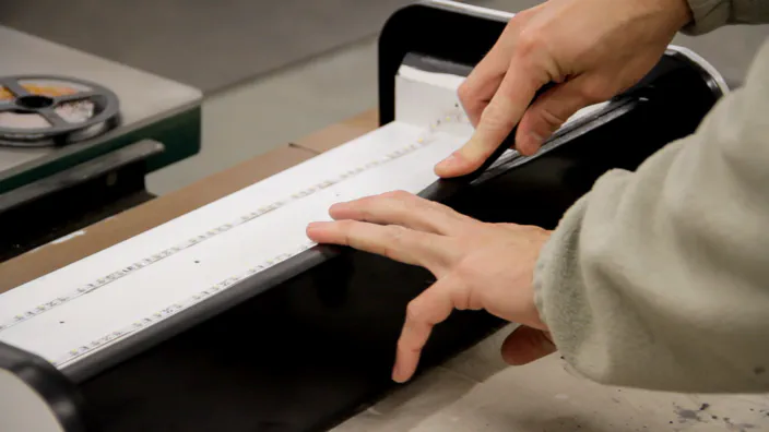 Plastic T-Molding is inserted into the slot in the front edge of the lightbox.