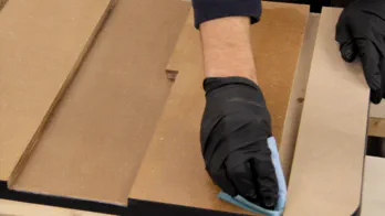 Boiled linseed oil is applied to the table with a rag.