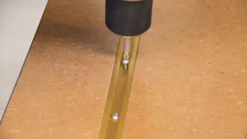 T-track is screwed into place on top of the table.