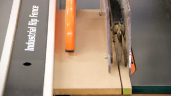 A short strip of MDF is cut on the table saw.