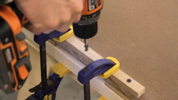 A thin cleat is screwed into the bottom of the table.