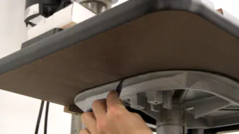 A pencil marks a line on the bottom of the table.