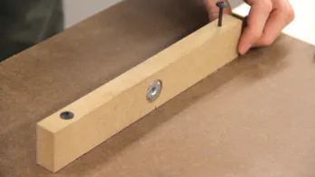 A thicker piece of MDF with a T-nut is screwed into the table bottom.