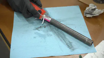 Removing stickers on steel pipe.