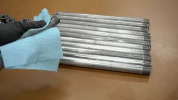 Removing stickers on steel pipe.