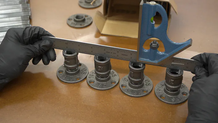 A straight edge is used to check for level feet.