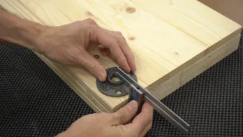 A square is used to measure the location of the legs on shelving.