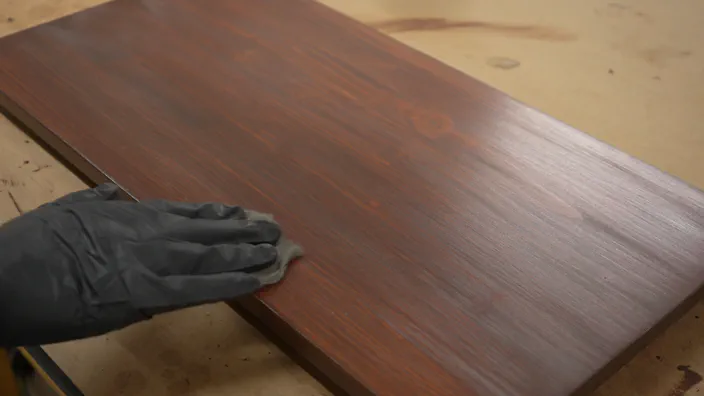 Stained wooden shelving is lightly sanded.