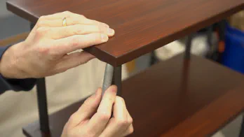 A pen is used to mark the location of screw holes.