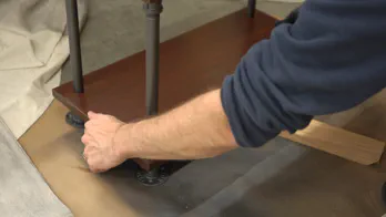 Caulk is applied to the leg couplings.