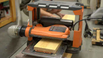 Surfacing a board with a planer.