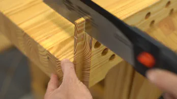 A miter saw trims the guide rail.