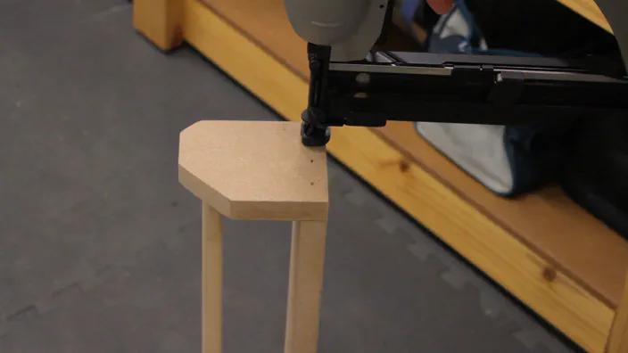 A nailgun is used to attach the side to the back of the rack.