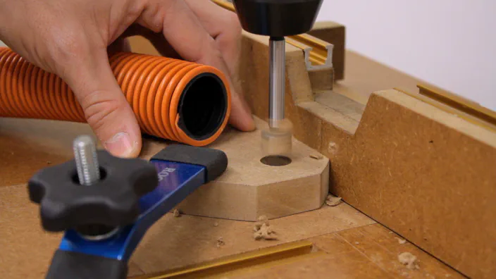 A drill press is used to make a hole in the rack side.