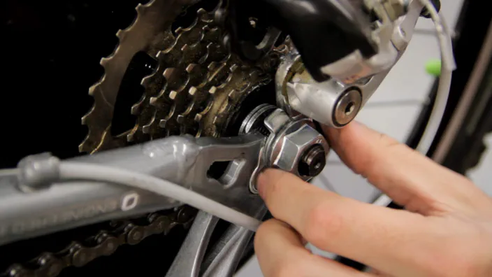 An axle nut installed on an electric bicycle wheel.