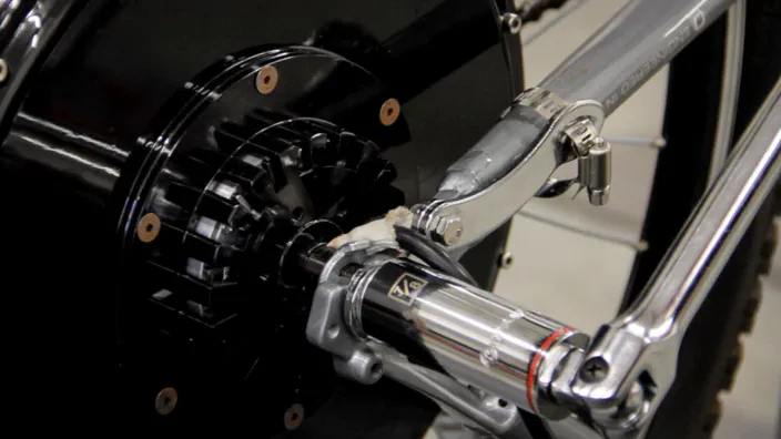 A socket wrench is used to secure an electric bicycle wheel.