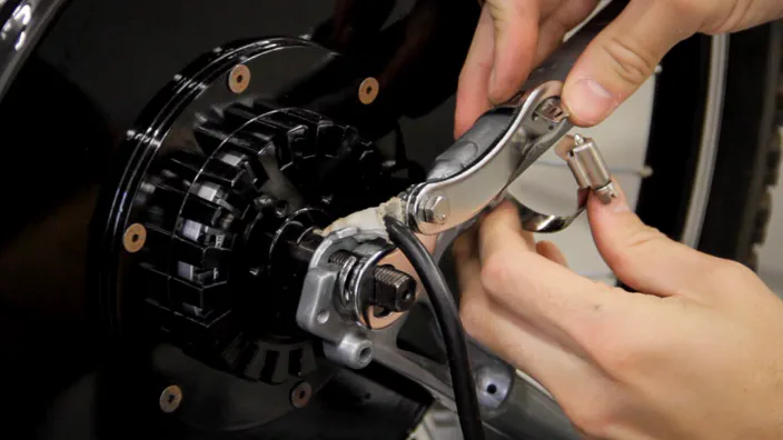 A torque arm installed on an electric bicycle wheel.