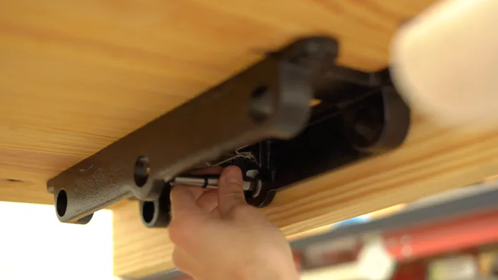 A Forstner bit is used to mark the hole locations.